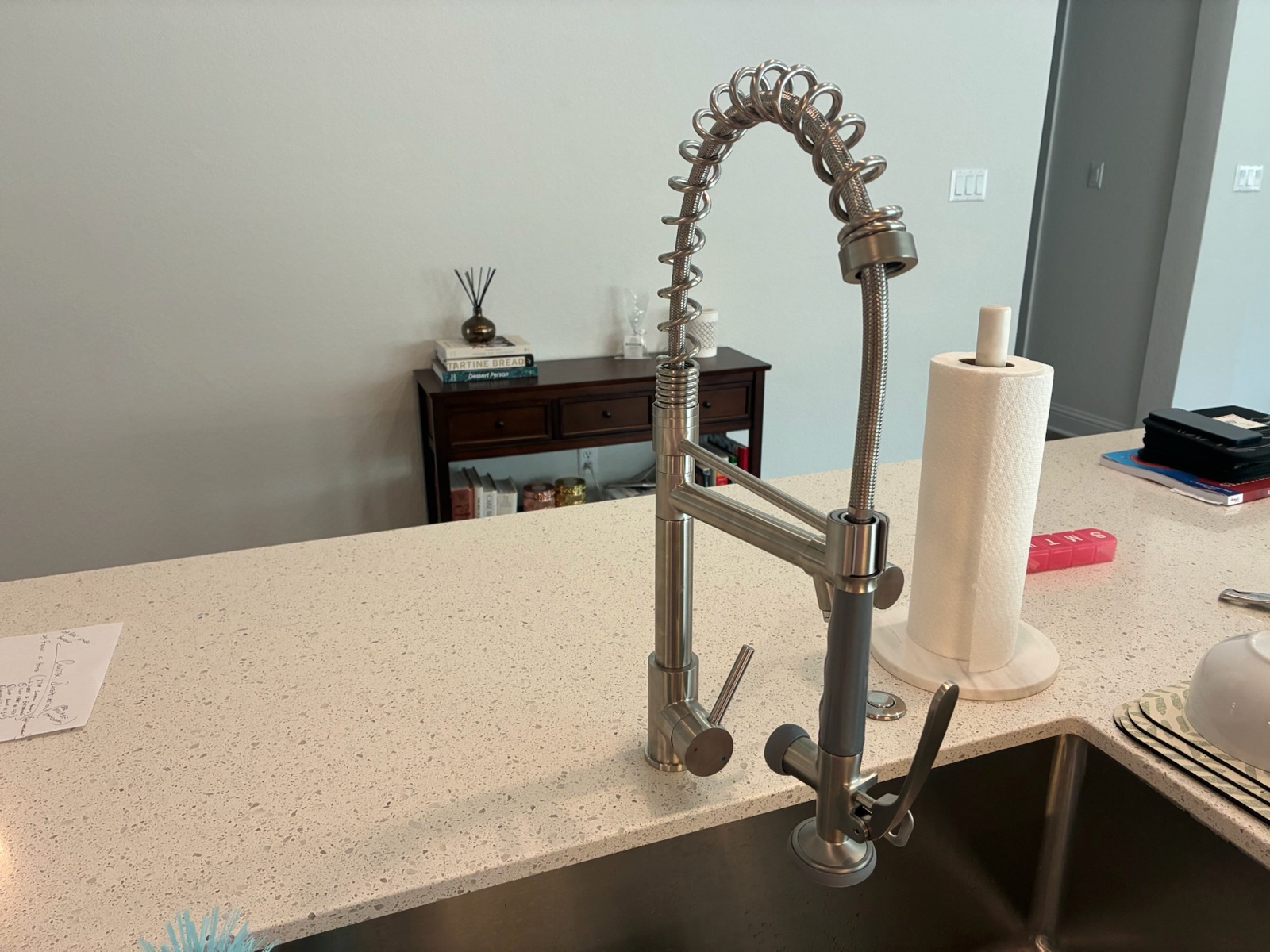New stainless commercial-style pull-down kitchen faucet after replacement